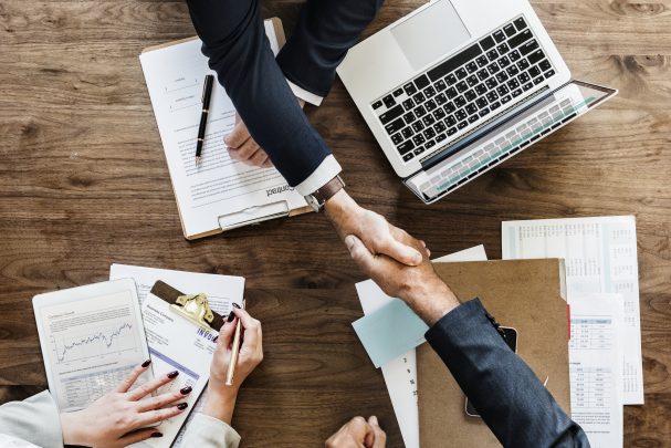 Businesspeople shaking hands together